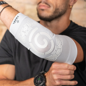 Close-up of a man wearing the white ELBOW Support Premier Padel elbow brace